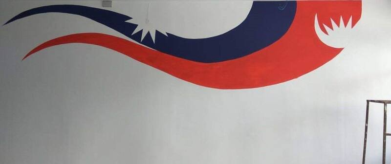 Mural of Nepal flag design painted on a wall